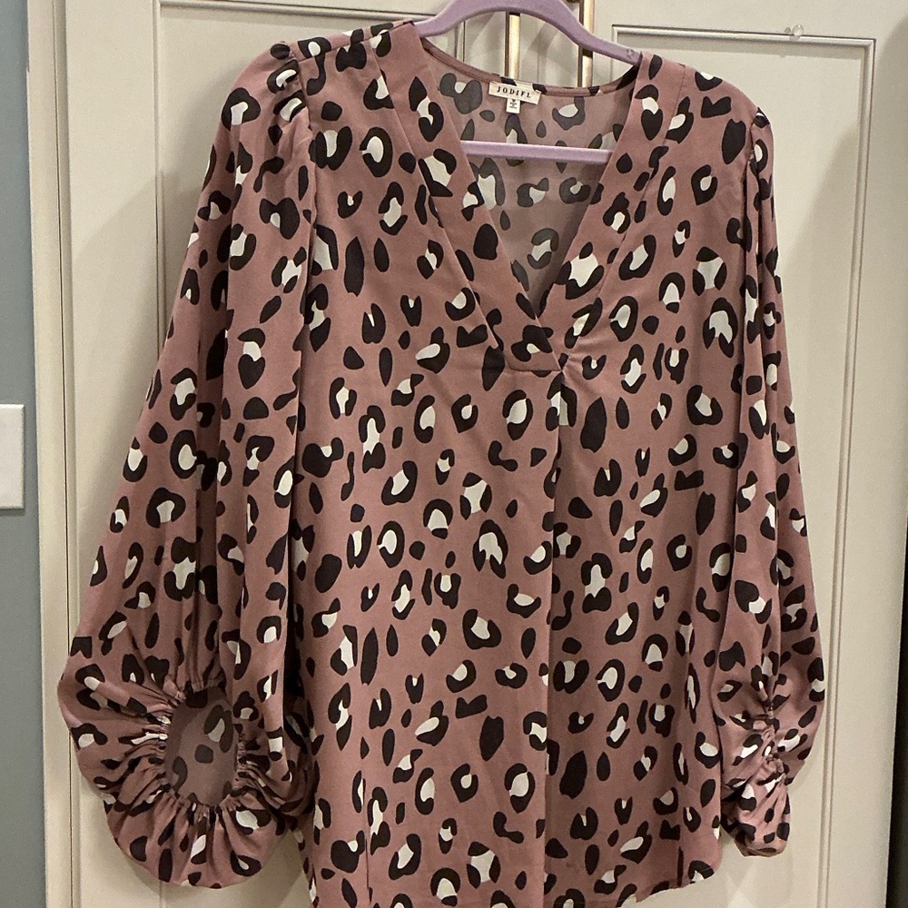 Women’s pink animal print V-neck blouse.
